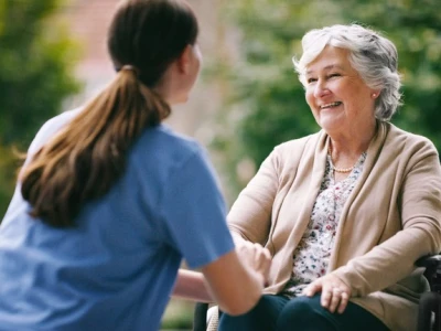 Home health aide providing compassionate care to elderly woman
